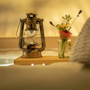 Oil lamp and a vase of flowers on a table