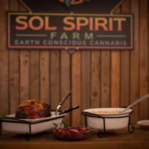 Roast and salad served in front of a Sol Spirit Farm sign