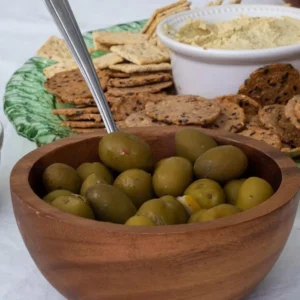 Appetizer board with olives, crackers and dip