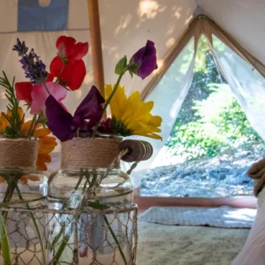 Fresh flowers in a vase inside a bell tent
