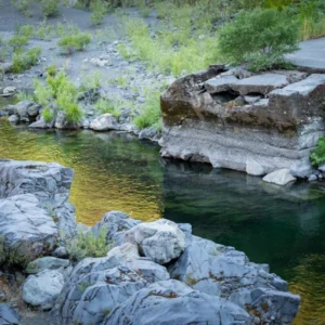 Low-water bridge over a clear green river