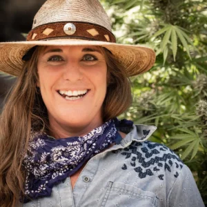 Smiling woman in a wide-brimmed hat and scarf